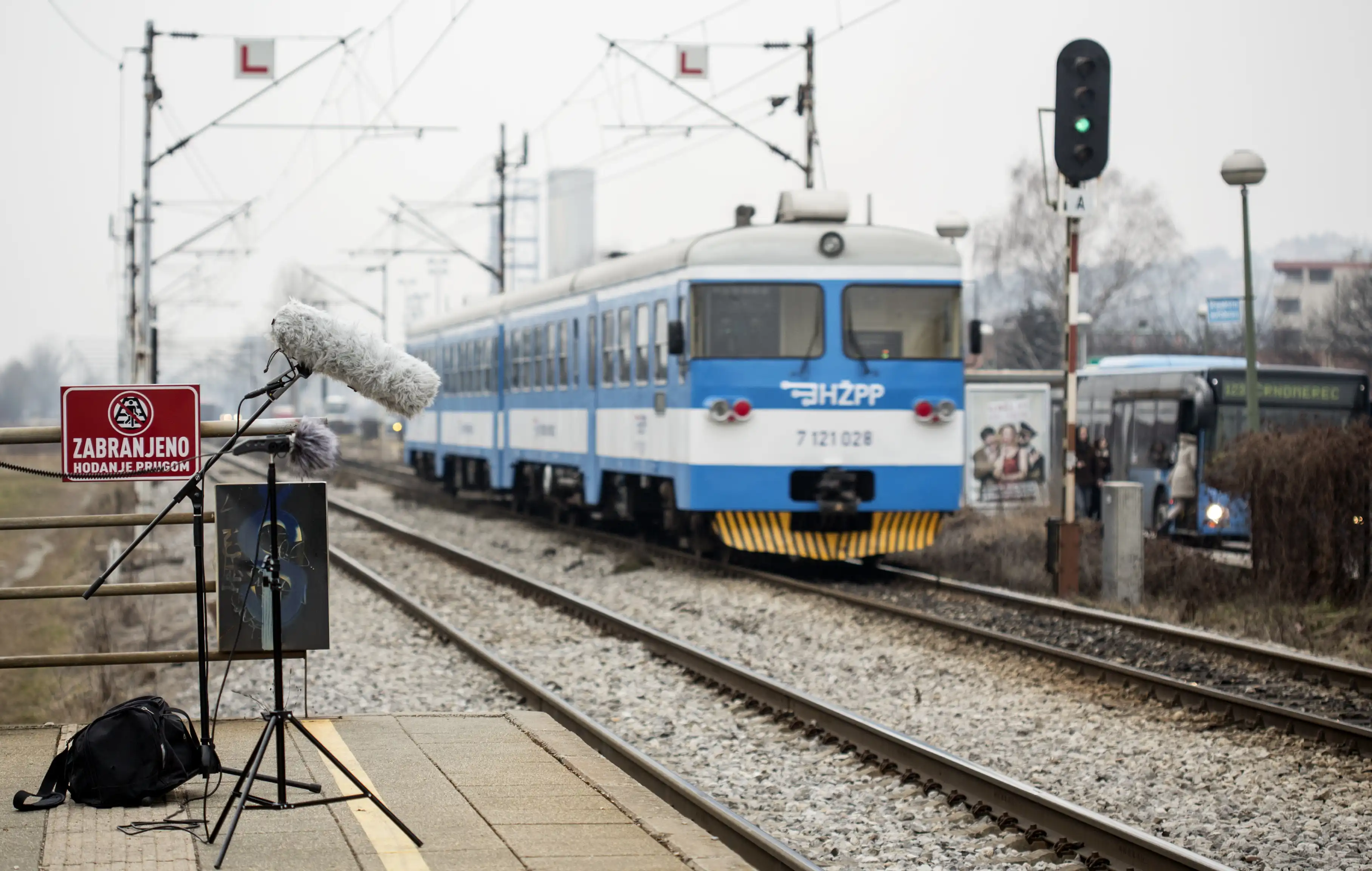 Working garage with Matko sitting at the computer a branko sitting near the recording tools.