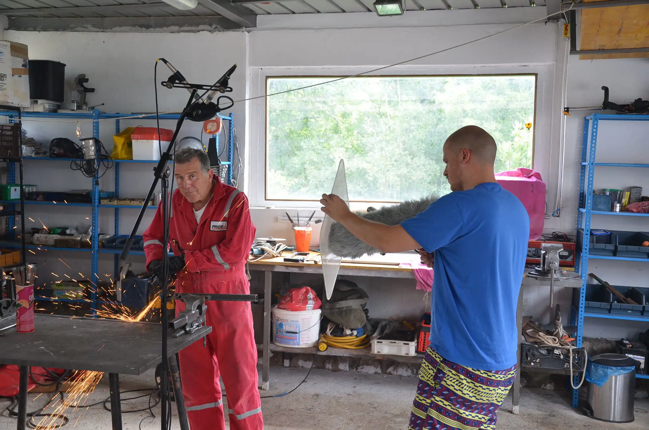Branko is operating a powertool while Matko is pointing the shotgun microphone at it.
